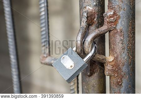 Locked Lock Old Rusty Metal Door Close Up. Antique Slide Steel Locked Shutter Door. The Lock, On The