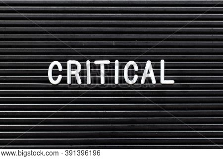 Black Felt Board With White Alphabet In Word Critical Background