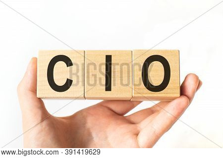 Hand Holds Wooden Cubes With Letters Cio. Business Concept Image.