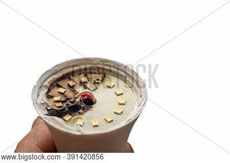 Burned Out, Faulty, Blackened Led Light Bulb In A Person Hand, Isolated On A White Background