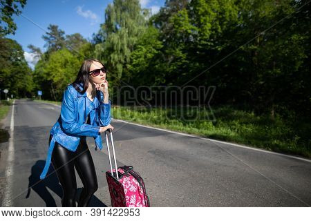 A Young Girl Stops By Hitchhiking To Shorten The Travel Time To The Arranged One. A Hot Day Can Be F