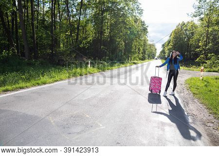 A Young Girl Stops By Hitchhiking To Shorten The Travel Time To The Arranged One. A Hot Day Can Be F