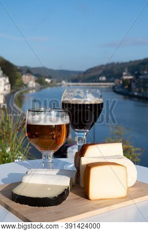 Glass Of Belgian Abbey Beer And Tasting Of Cheeses Made With Trappist Beer And Fine Herbs With View