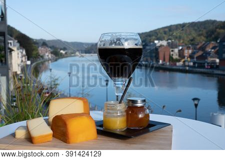 Glass Of Belgian Abbey Beer And Tasting Of Cheeses Made With Trappist Beer And Fine Herbs With View