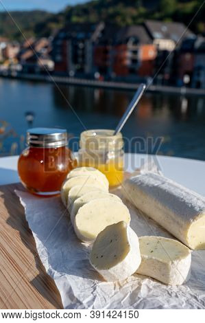 Belgian Abbey Cheese Fagotin In Pieces With Jam Served Outdoor With View On Maas River And Center Of