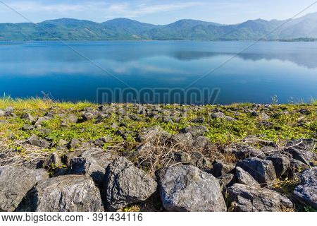 View Of Reservoir Blue Sky And Green Grass