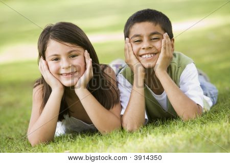 Middle Eastern Children Laying On Grass In Park