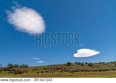 Riesco Island, Chile - December 12, 2008: Falling Meteor And Flying Dish Spaceship White Cloud In De