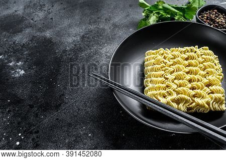 Dry, Raw Quick Cooking Noodle, Instant Noodles. Black Background. Top View. Copy Space