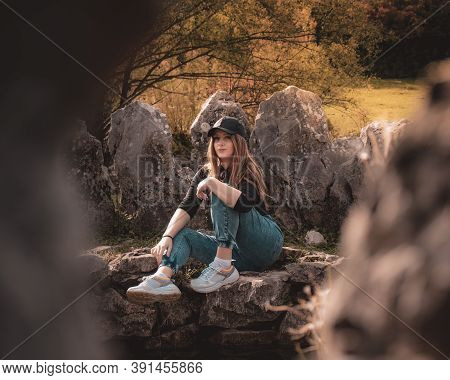 Zoomed Full Body Portrait Of An Attractive Brunette Sitting On A Well At The Rajcica Wells Natural L