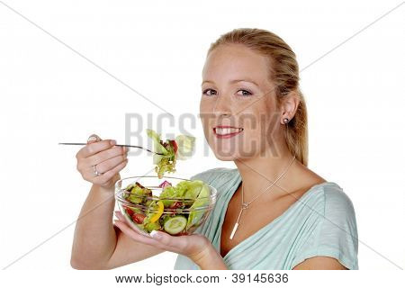 a young woman eating a fresh salad at lunch. healthy diet with vitamins.