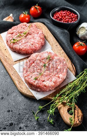 Raw Chicken Patty, Ground Meat Cutlets On A Chopping Board. Organic Mince. Black Background. Top Vie
