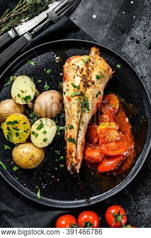Baked In Tomatoes Monkfish With Potatoes And Vegetables. Black Background. Top View