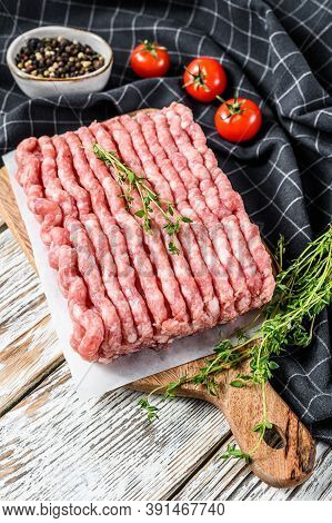 Raw Minced Pork On A Chopping Board. Organic Ground Meat, Forcemeat. White Background. Top View