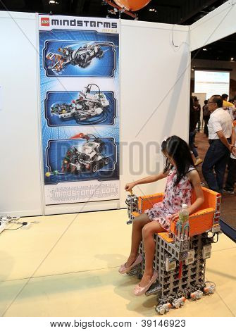 SUBANG JAYA - NOVEMBER 10: An unidentified student tests a wheel-chair robot at the World Robot Olympaid on November 10, 2012 in Subang Jaya, Malaysia. This year's theme is Robots connecting people.