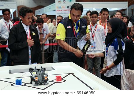 SUBANG JAYA - NOVEMBER 10: Unidentified team members prepare their robot for the competition at the World Robot Olympaid on November 10, 2012 in Subang Jaya, Malaysia.