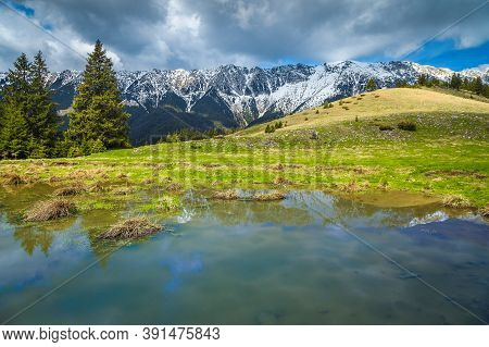 Amazing Alpine Landscape With Small Lake And High Snowy Piatra Craiului Mountains, Near Pestera Vill