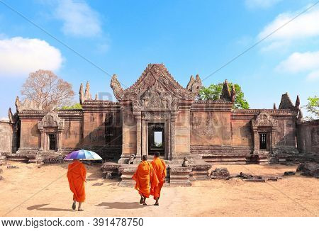 Three buddhist monks go to Gopura I in Preah Vihear Temple complex (Prasat Phra Wihan), Cambodia. UNESCO world heritage site