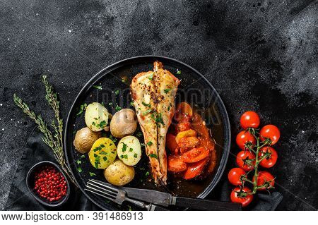 Cooking In Tomatoes Monkfish Fish With Baked Potatoes. Fresh Seafood. Black Background. Top View. Co