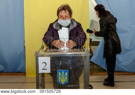 Velyka Dobron, Ukraine - October 25, 2020: Senior Woman Wearing Protective Mask Votes In Local Elect
