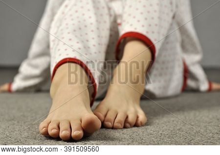 Legs Of A Child 8-10 Years Old In Pajamas. Foot