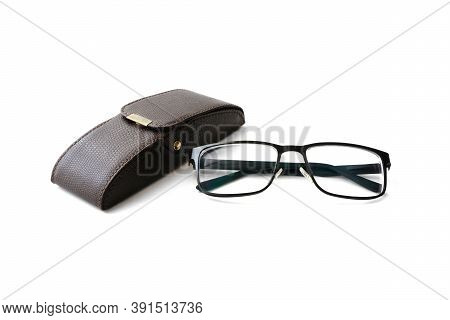 Stylish Dioptrics Black Eyeglasses With Hard Case Made Of Genuine Brown Leather. Isolated On White B