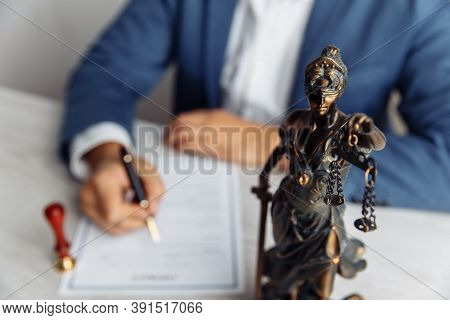 Lawyer Office. Statue Of Justice With Scales Close-up And Lawyer Sighning A Document. Legal Law, Adv
