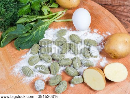 Potato Gnocchi With Spinach Being Prepared Among The Several Ingredients On The Wooden Board, Top Vi