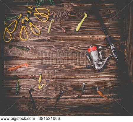 Fishing Tackle On A Wooden Background. Studio Photo With Place For Text. Spinning Rod With A Reel, S