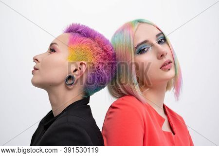 Young Lesbian Woman Couple With Vivd Colored Short Hair And Jackets Posing On White Background. Pier