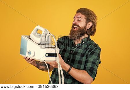 All You Need Is Iron. Man Ironing At Home. Happy Man Ironing Clothes. Man Concentrated On Ironing A 