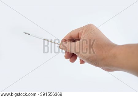 The Close-up Handheld Thermometer Is Isolated In A White Background
