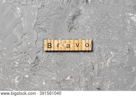 Bravo Word Written On Wood Block. Bravo Text On Cement Table For Your Desing, Concept