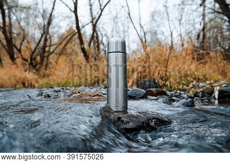 Steel Vacuum Thermos, Outdoor. A Hiking Flask Is In The Stream. Concept For Outdoor Activities, Hot 