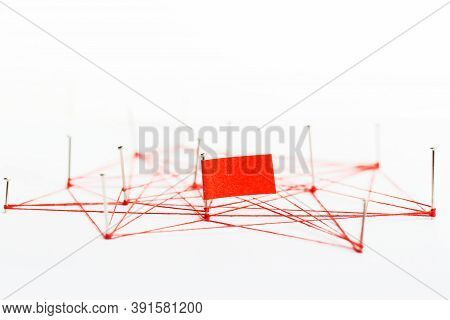 A Large Mesh Of Pins Tied Together With A Red Cord. Communication, Network Concept.