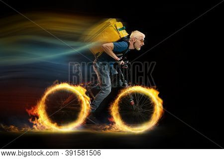 Speed. Fast Delivery Service - Deliveryman On Bicycle Driving With Order In Fire On Dark Background.