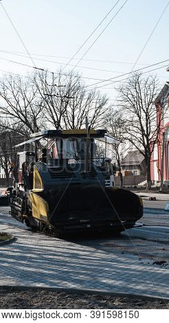 Industrial Asphalt Paver Machine Laying Fresh Asphalt On Road Construction Site On The Street. A Pav