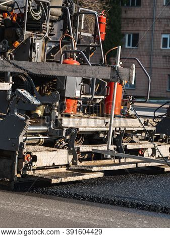 Industrial Asphalt Paver Machine Laying Fresh Asphalt On Road Construction Site On The Street. A Pav