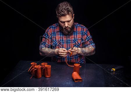 Craftsman Working With Leather Works With Leather Goods At His Place Of Work