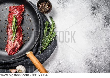 Raw Strip Vegas Steak In A Pan With Cooking Ingredients. Gray Background. Top View. Copy Space
