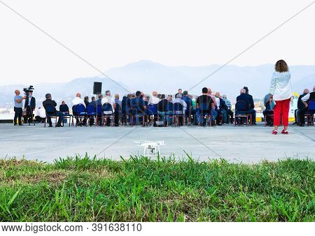 17th Of October, Batumi, Georgia. Group Of People Sitting On The Chairs Outside In Public Event With