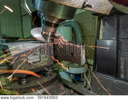 Sloped Disk Industrial Milling Process With Sparks - Close-up With Selective Focus And Blur