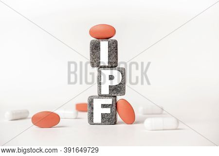 A Group Of White And Red Pills And Cubes With The Word Ipf Idiopathic Pulmonary Fibrosis On Them, Wh