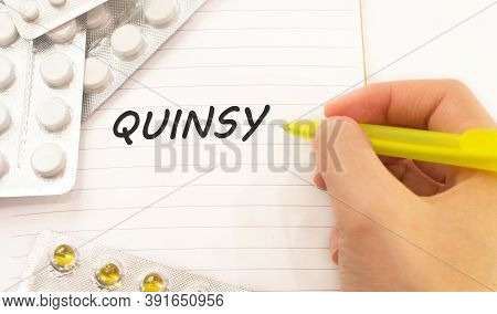 Text Quinsy On White Background. There Are Various Pills And Vitamins Around. Medicine Concept