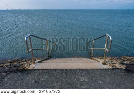 A Pier On The North Sea Coast With A Sign Bathing Is Prohibited