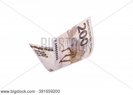 200 Reais Note Falling, With Selective Focus. Two Hundred Reais From Brazil Isolated White Backgroun