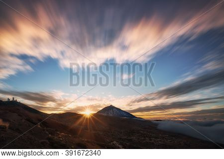 View Of A Volcano In A Sunset And The Sky Full Of Clouds With Beautiful Colors