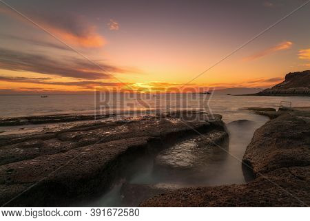 Puddle In The Sea During A Sunset And High Clouds