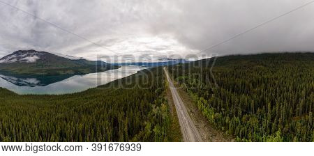 Beautiful Panoramic View Of Scenic Road Alongside Peaceful Lake Surrounded By Mountains In Canadian 