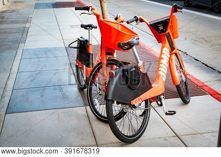 Los Angeles, California - October 16 2019: Jump Dockless E-bikes/ Electric Bikes Parked On Sidewalk.